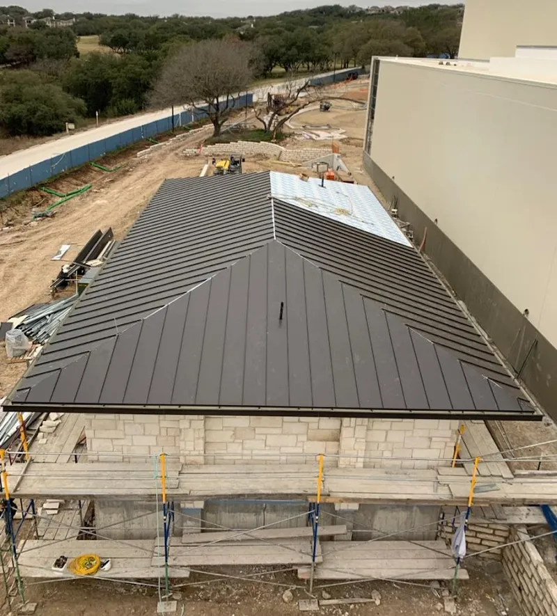 Metal roof new construction with scaffolding in La Homa