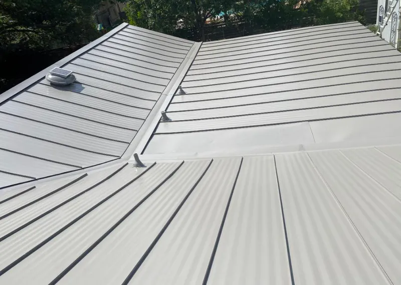 Solar attic fan installed on a metal roof for Roof Ventilation in La Homa
